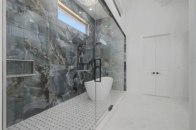 a bathroom with a bathtub and shower