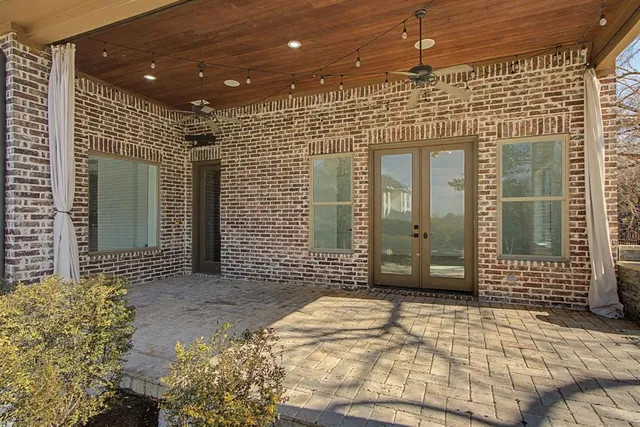 a view of a roof deck with wooden fence and trees