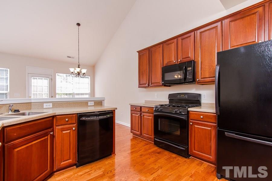 5445 Brandy Bay Road Raleigh, NC 27613 - Photo 14 of 25 a kitchen with stainless steel appliances granite countertop a stove a sink dishwasher a refrigerator and a microwave