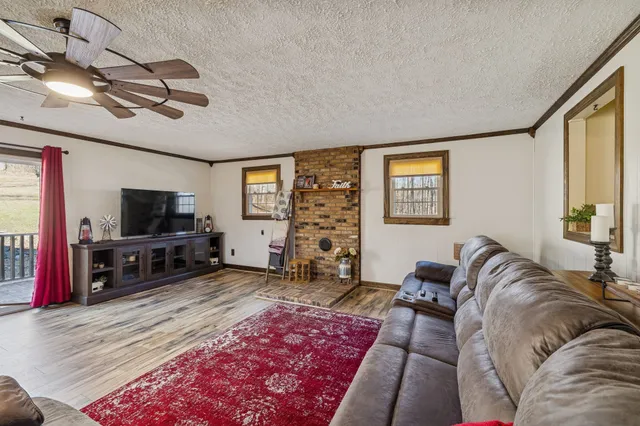 a bathroom with a granite countertop sink a toilet a mirror and shower