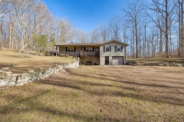 a front view of a house with a yard covered in snow