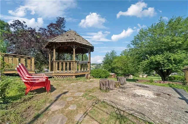 a view of a chair and table in the backyard