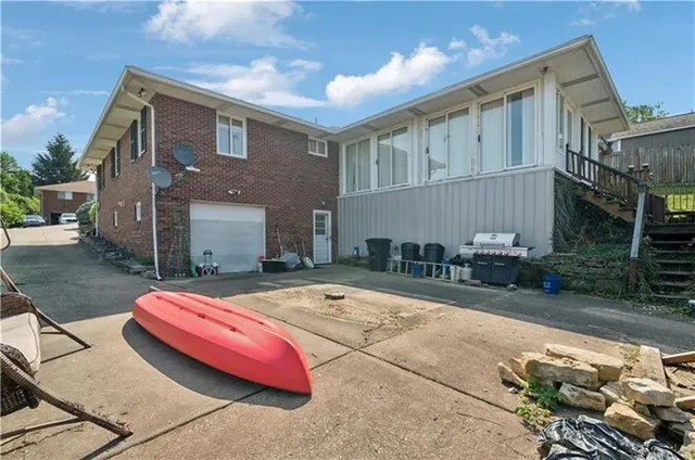 a backyard of house with barbeque oven table and chairs