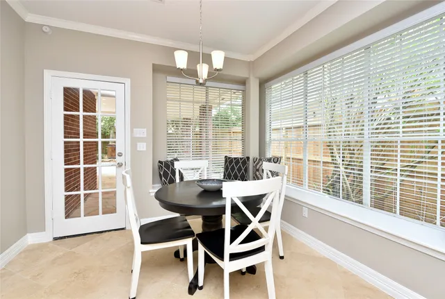a view of a dining room with furniture large windows and wooden floor