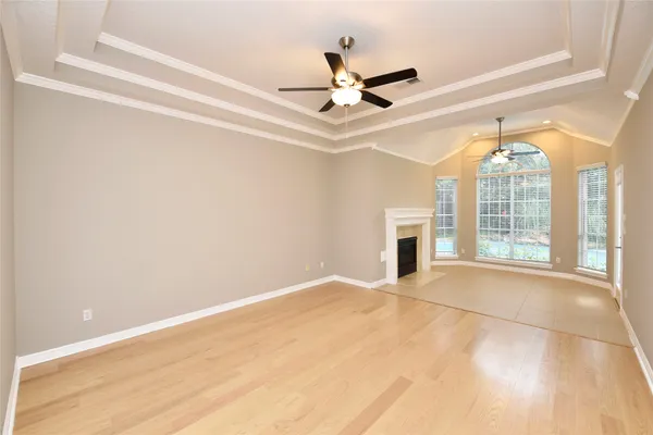 a view of an empty room with a fireplace and a window