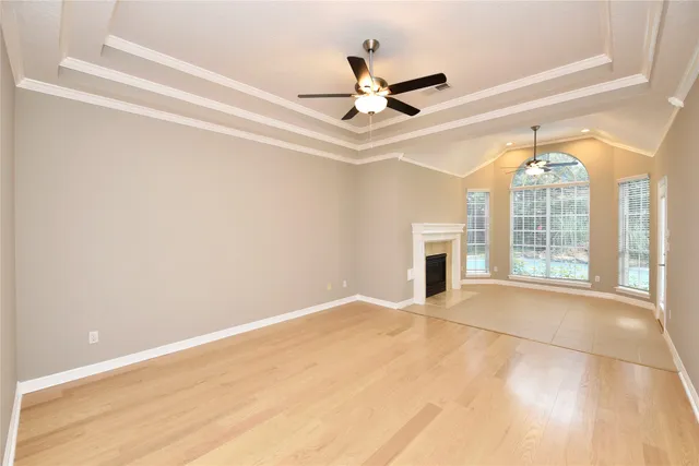 a view of an empty room with a fireplace and a window