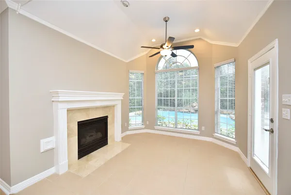 a view of a big room with wooden floor and windows