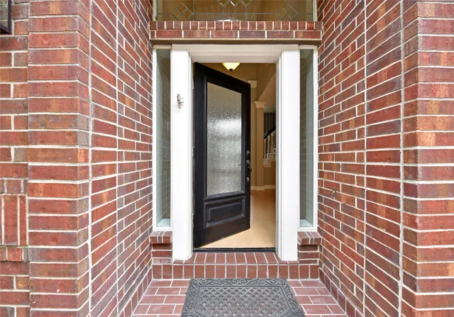 a view of a livingroom with a chandelier curtains and large windows