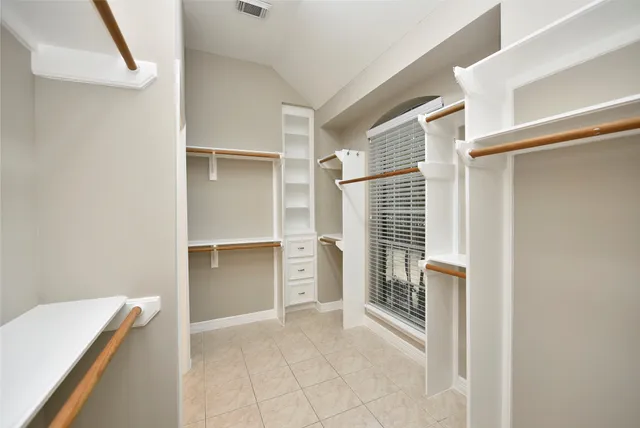 a view of a hallway with windows and stairs