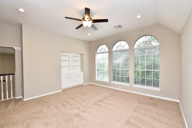 a view of a big room with closet and chandelier fan