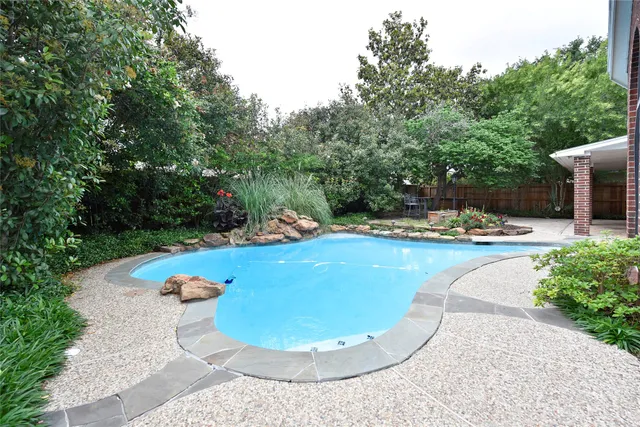 a front view of a house with swimming pool and porch