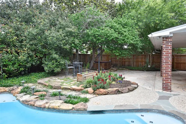 a front view of a house with swimming pool and porch