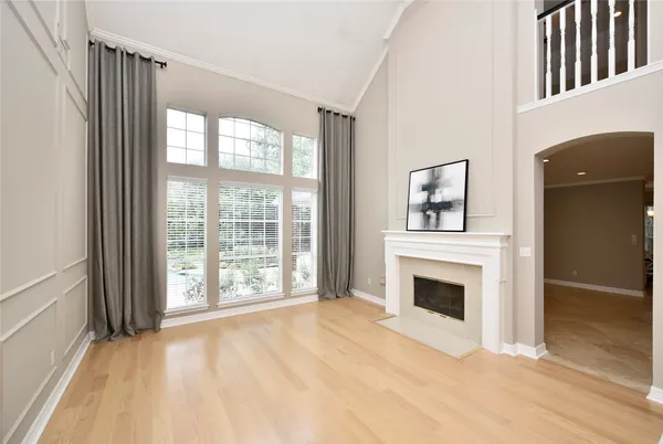 a view of an entryway with wooden floor fireplace and a way to kitchen