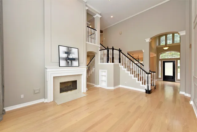 a view of an empty room with a fireplace and a window
