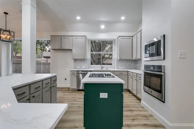a kitchen with stainless steel appliances granite countertop a stove and a refrigerator