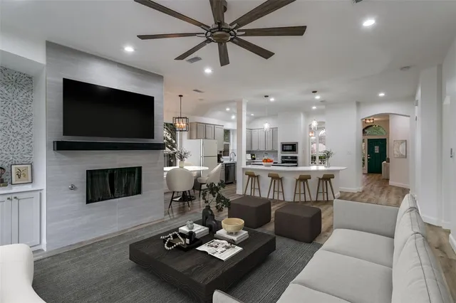 a living room with furniture a fireplace and a flat screen tv