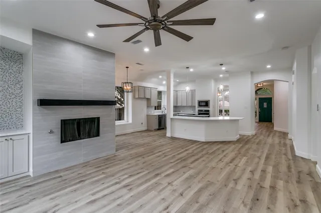 a view of a kitchen with a sink and a fireplace
