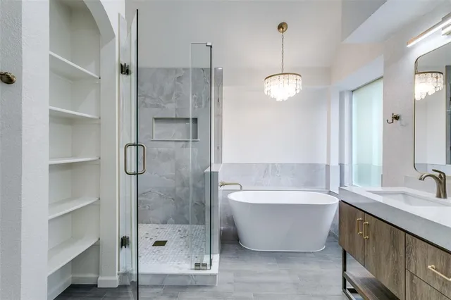 a bathroom with a large tub shower and sink