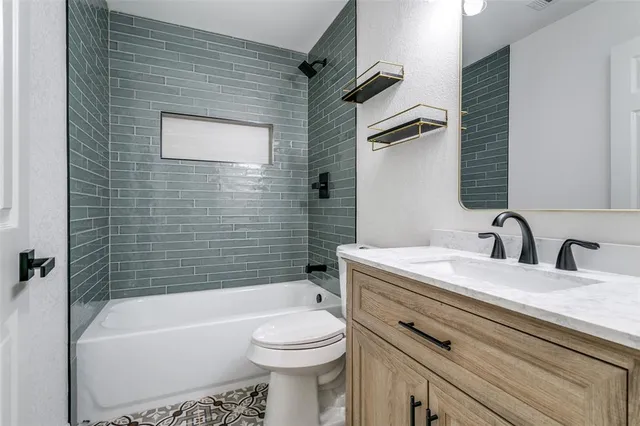 a bathroom with a sink a toilet and bathtub