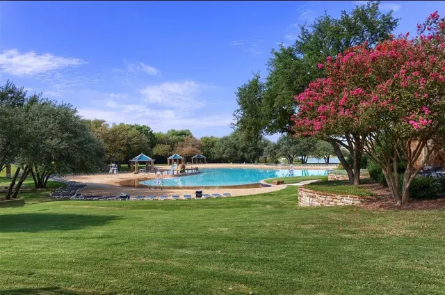 a view of a swimming pool with a yard
