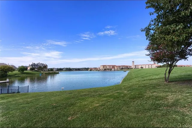 a view of a lake with houses in the back
