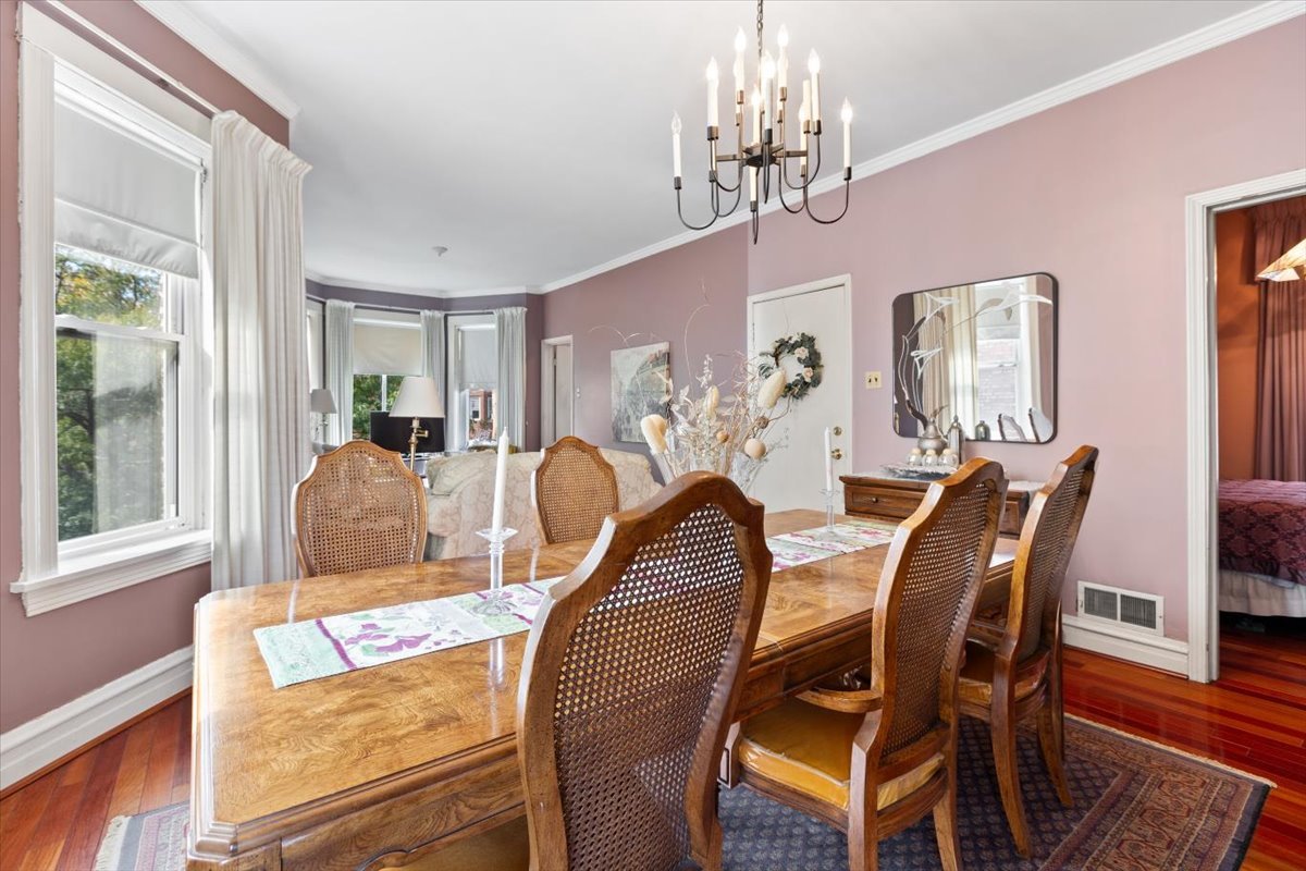 3911 North Kedzie Avenue Chicago, IL 60618 - Photo 11 of 35 a view of a dining room with furniture a chandelier and wooden floor