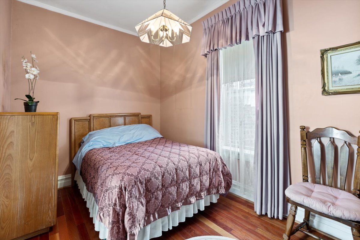3911 North Kedzie Avenue Chicago, IL 60618 - Photo 12 of 35 a bedroom with a bed and a chandelier