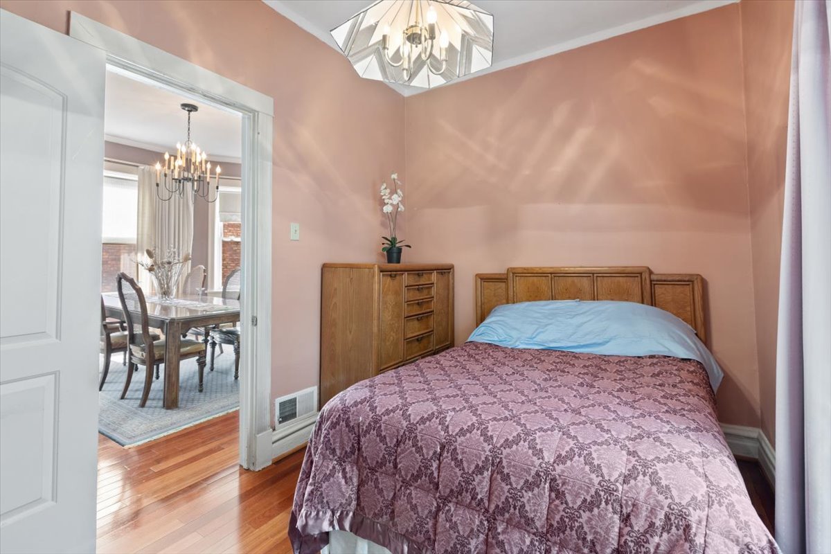 3911 North Kedzie Avenue Chicago, IL 60618 - Photo 13 of 35 a bedroom with a bed and a table with chair