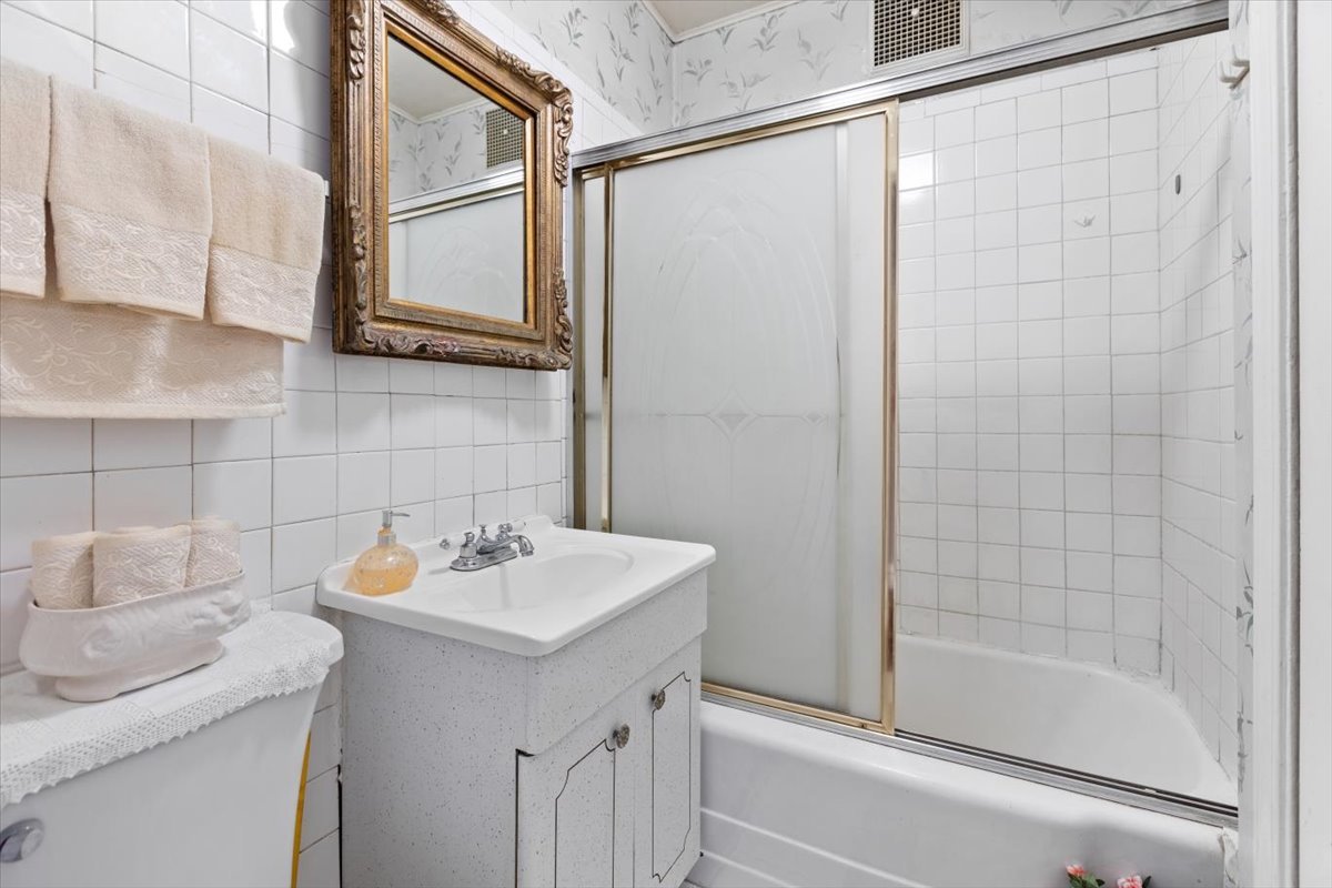 3911 North Kedzie Avenue Chicago, IL 60618 - Photo 14 of 35 a bathroom with a sink and a mirror