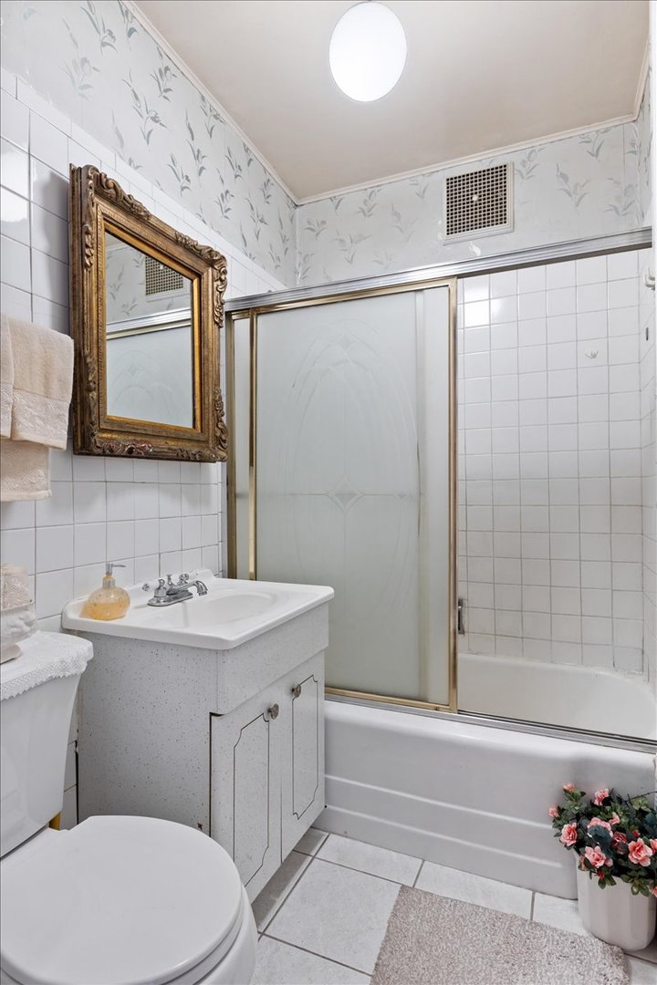 3911 North Kedzie Avenue Chicago, IL 60618 - Photo 15 of 35 a bathroom with a sink a toilet and shower
