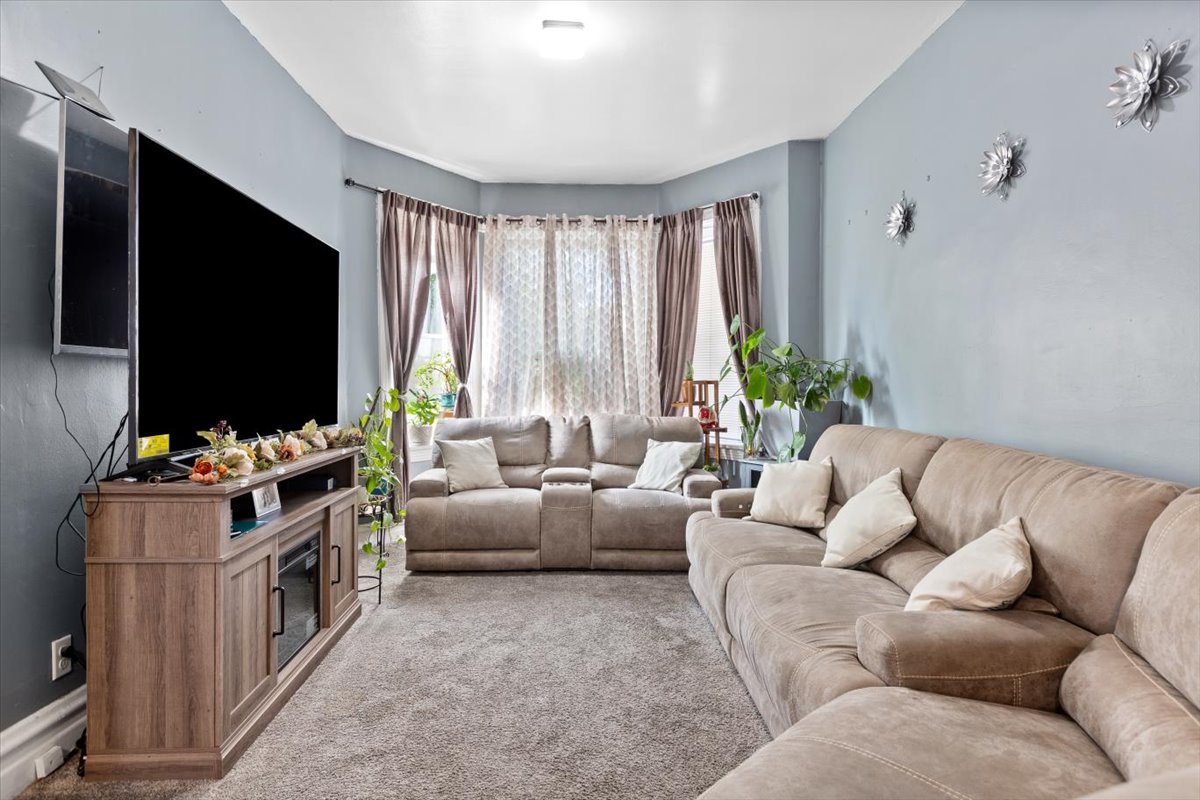 3911 North Kedzie Avenue Chicago, IL 60618 - Photo 20 of 35 a living room with furniture and a flat screen tv
