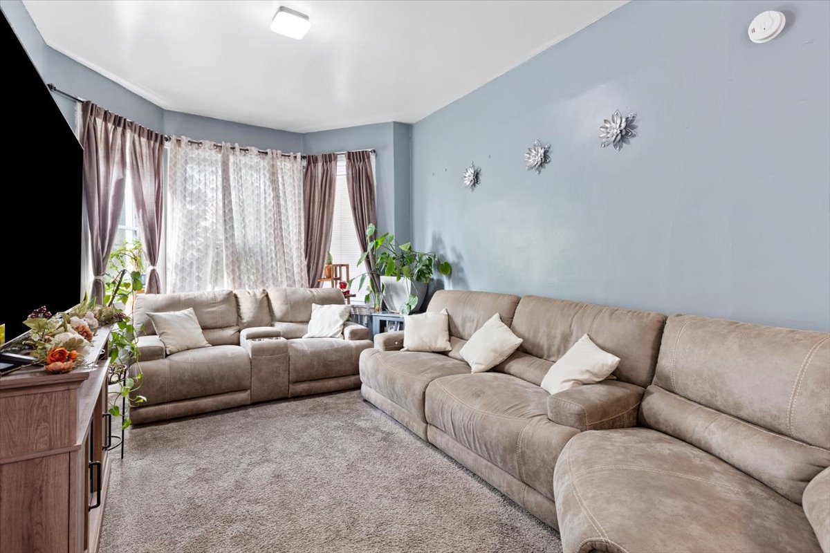 3911 North Kedzie Avenue Chicago, IL 60618 - Photo 21 of 35 a living room with furniture and a flat screen tv