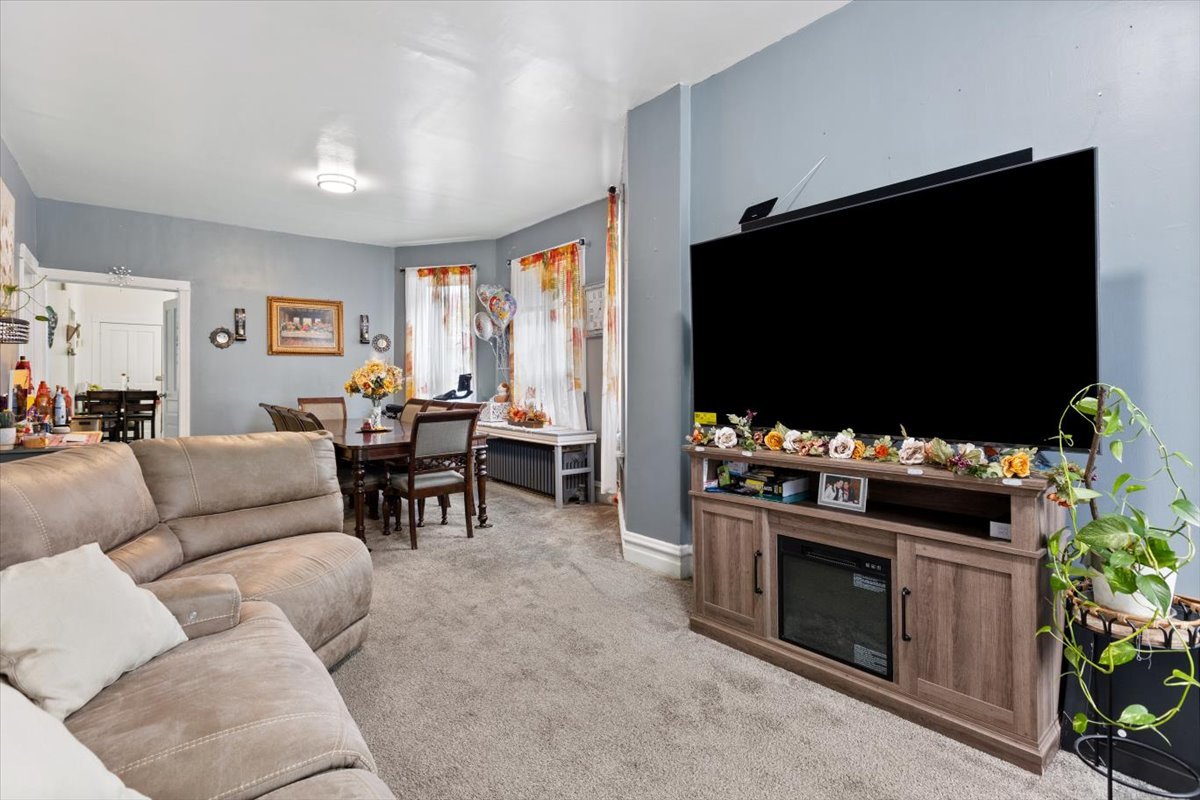 3911 North Kedzie Avenue Chicago, IL 60618 - Photo 22 of 35 a living room with furniture and a flat screen tv