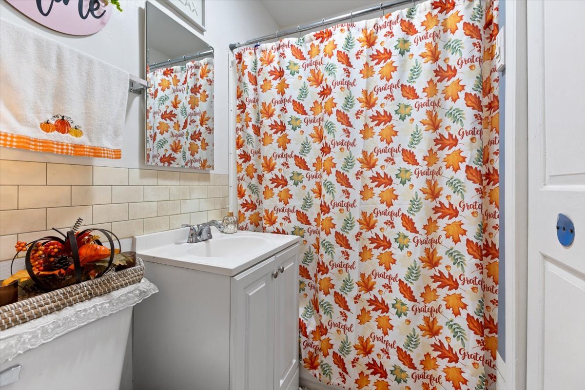 3911 North Kedzie Avenue Chicago, IL 60618 - Photo 26 of 35 a bathroom with a sink and a curtain