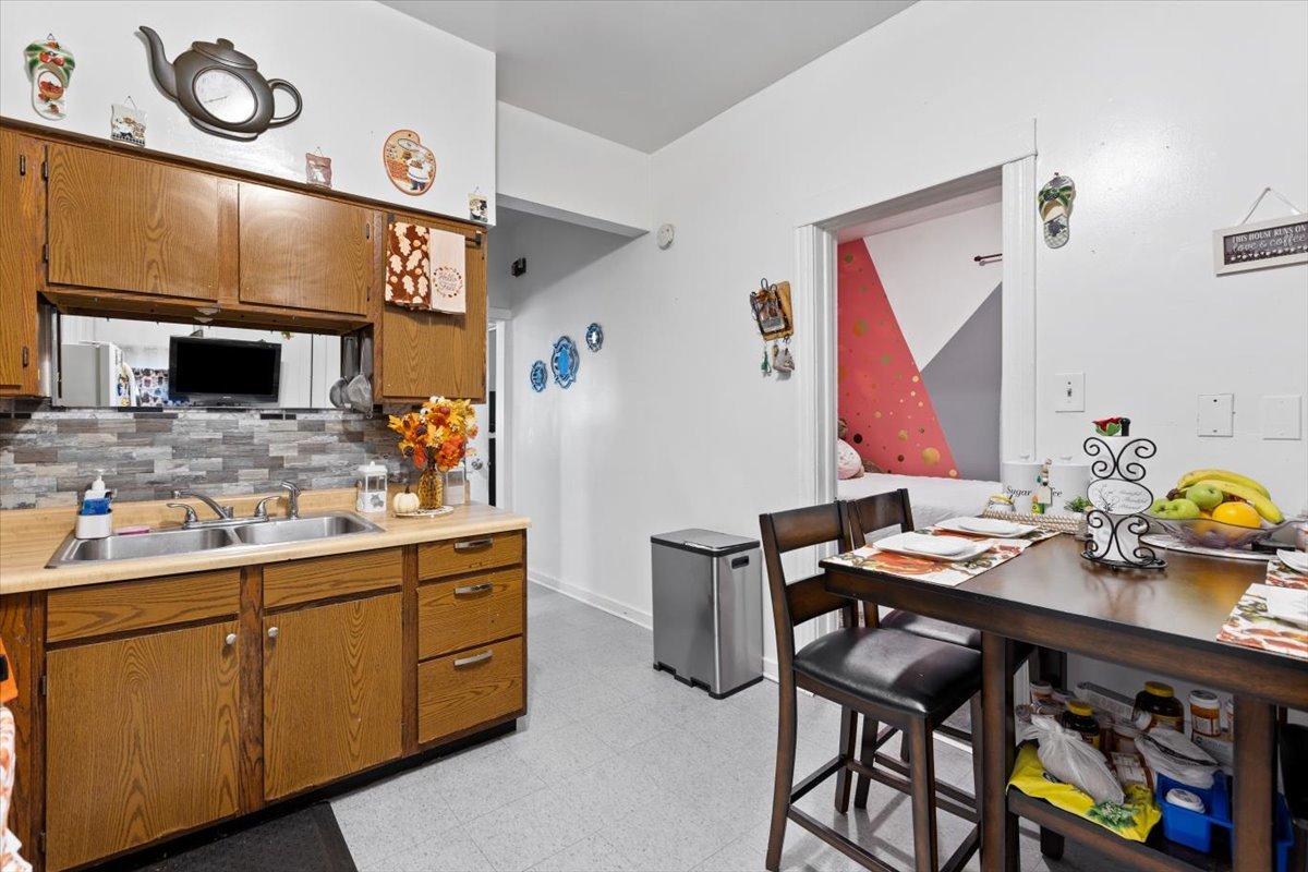 3911 North Kedzie Avenue Chicago, IL 60618 - Photo 29 of 35 a kitchen with a sink cabinets and stove