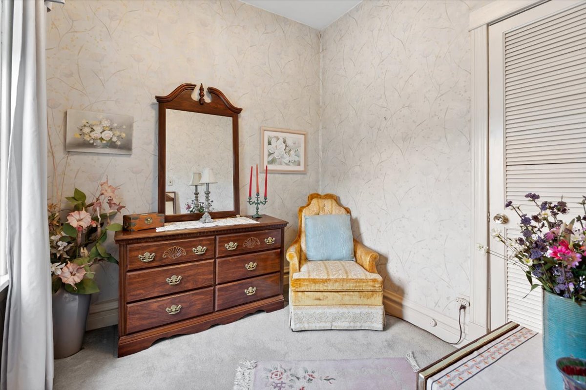 3911 North Kedzie Avenue Chicago, IL 60618 - Photo 7 of 35 a room with a dresser and a potted plant