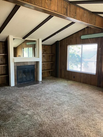 a view of empty room with a fireplace