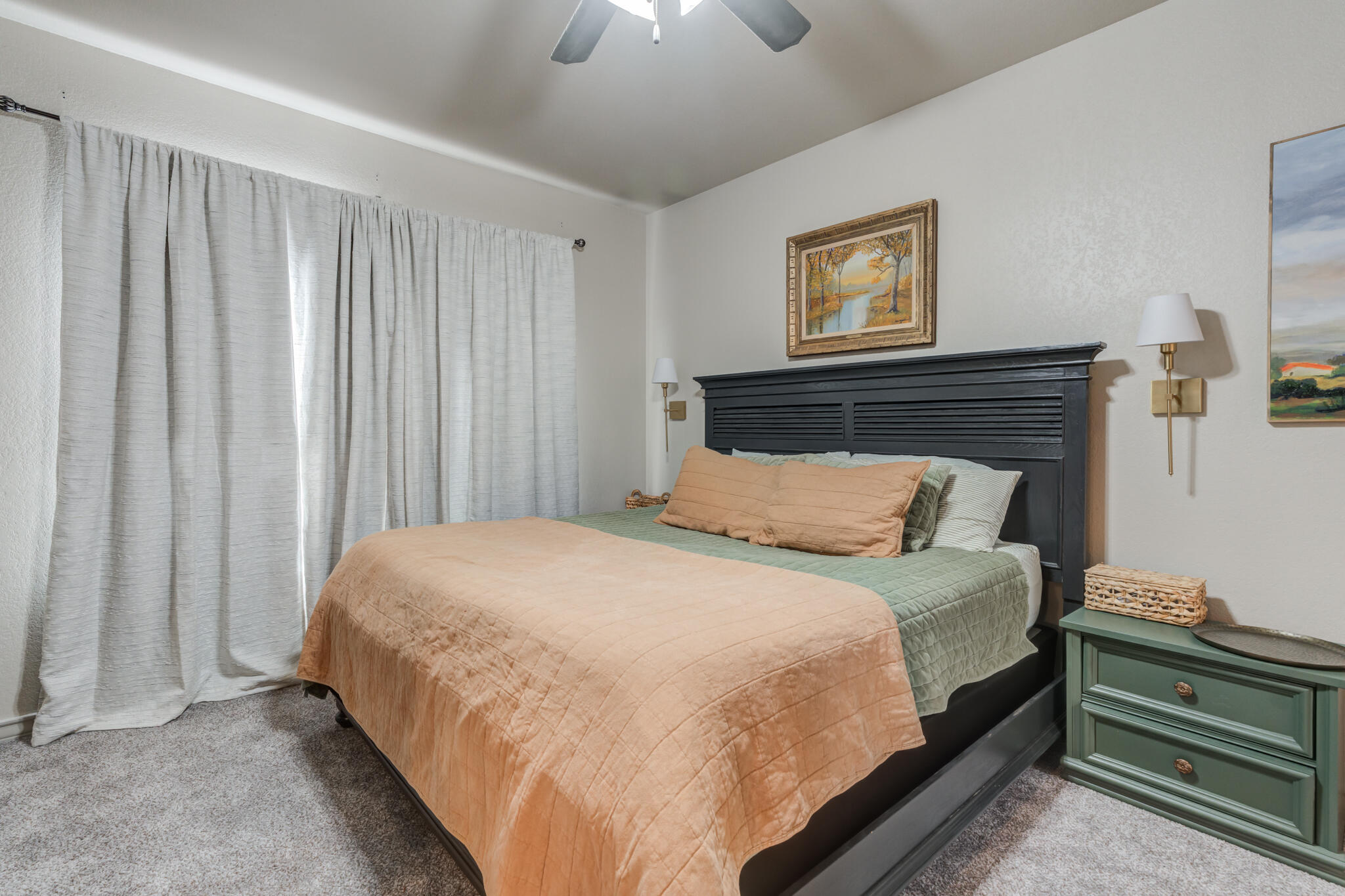7813 88th Street Lubbock, TX 79424 - Photo 11 of 21 a bedroom with a bed and a chandelier