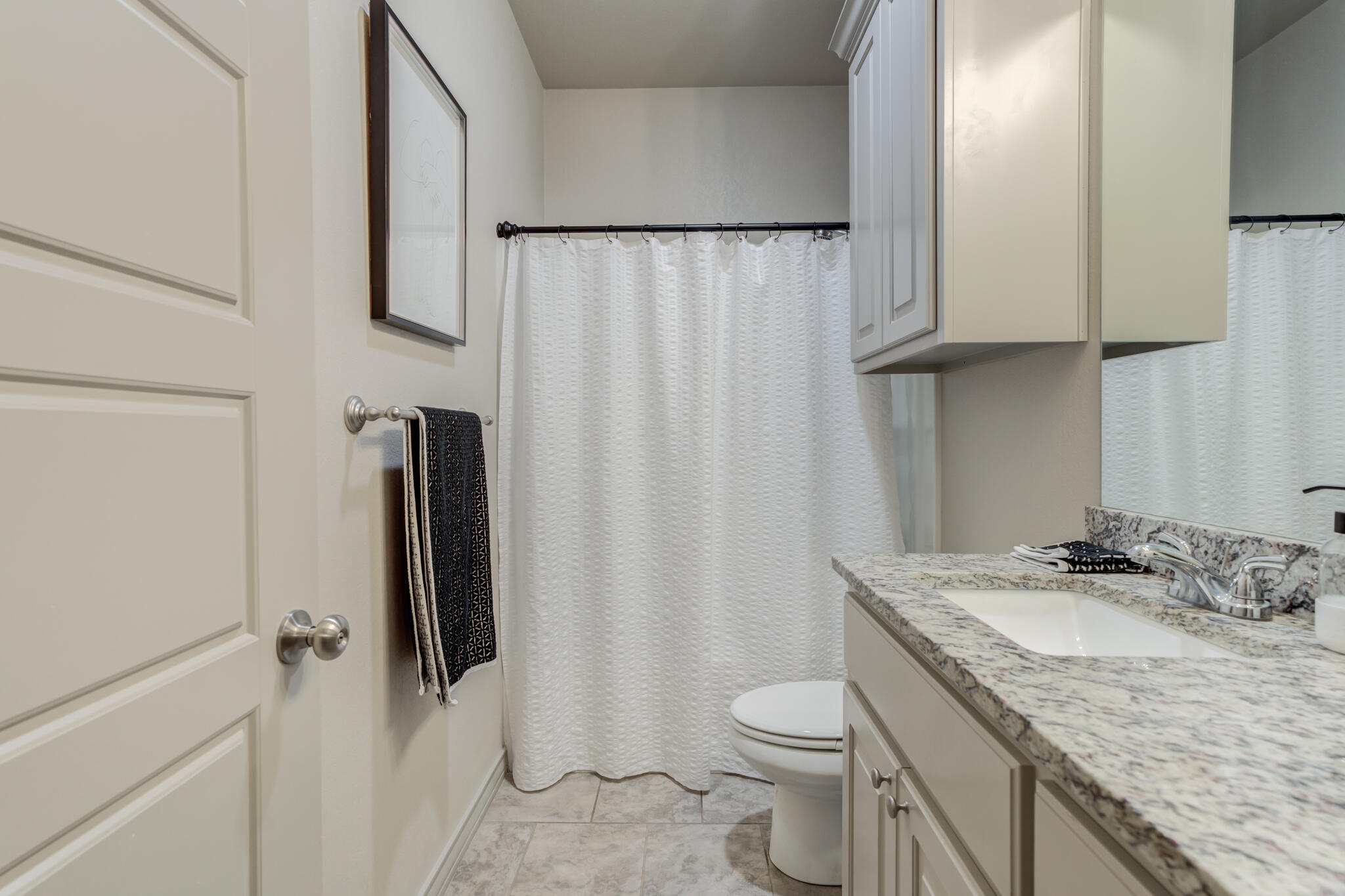 7813 88th Street Lubbock, TX 79424 - Photo 16 of 21 a bathroom with a granite countertop sink toilet and shower
