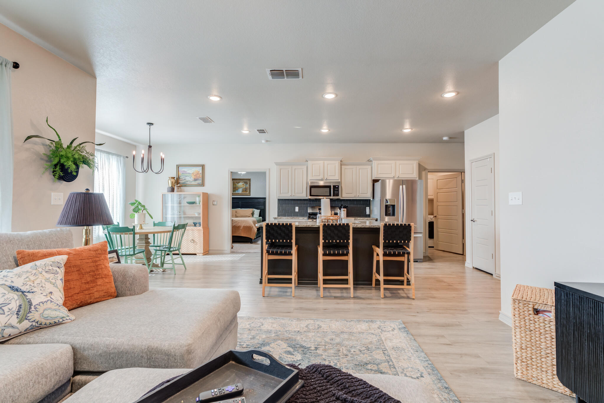 7813 88th Street Lubbock, TX 79424 - Photo 3 of 21 a living room with furniture a dining table and kitchen view