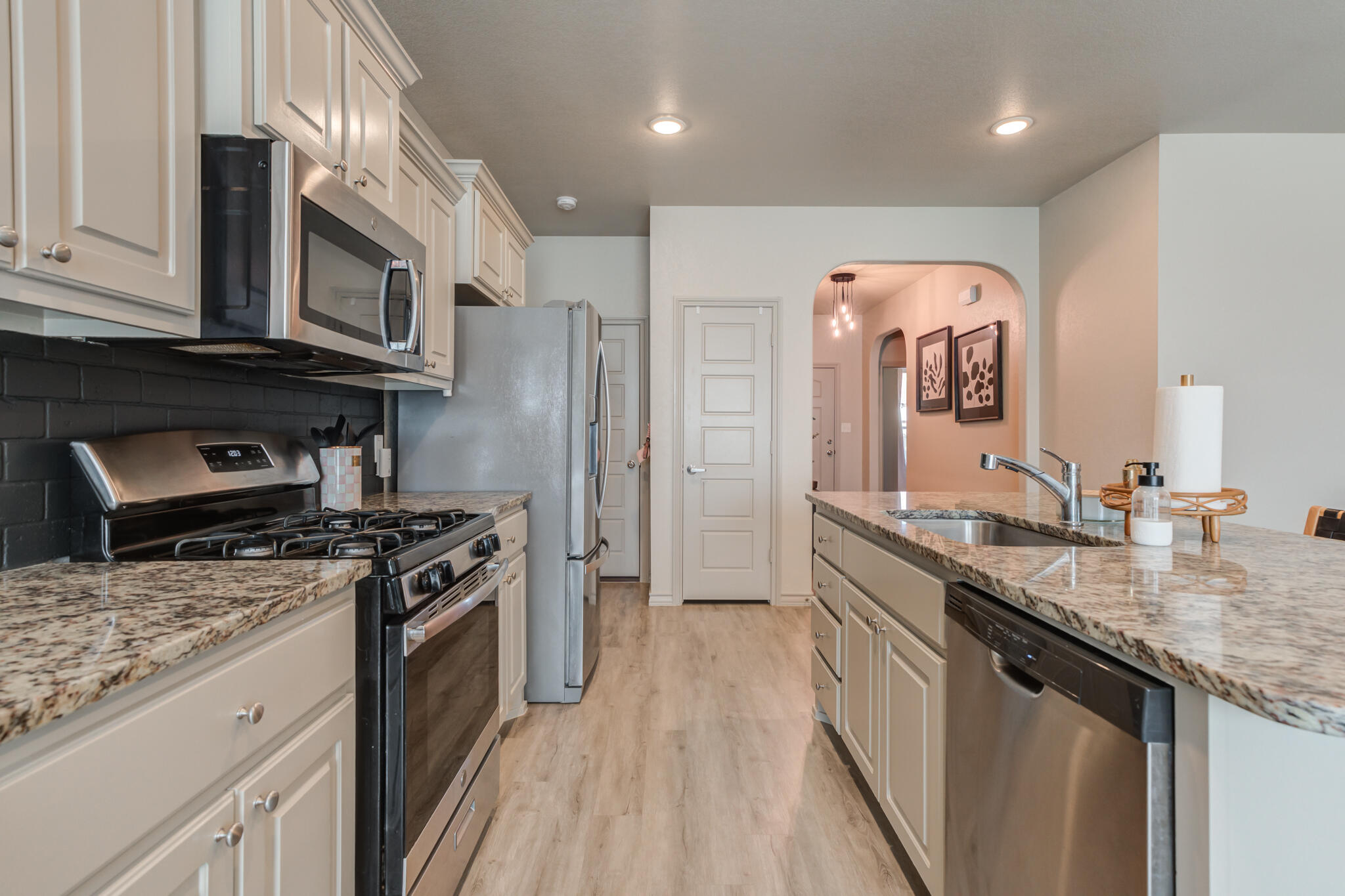 7813 88th Street Lubbock, TX 79424 - Photo 5 of 21 a kitchen with stainless steel appliances granite countertop a sink stove and refrigerator