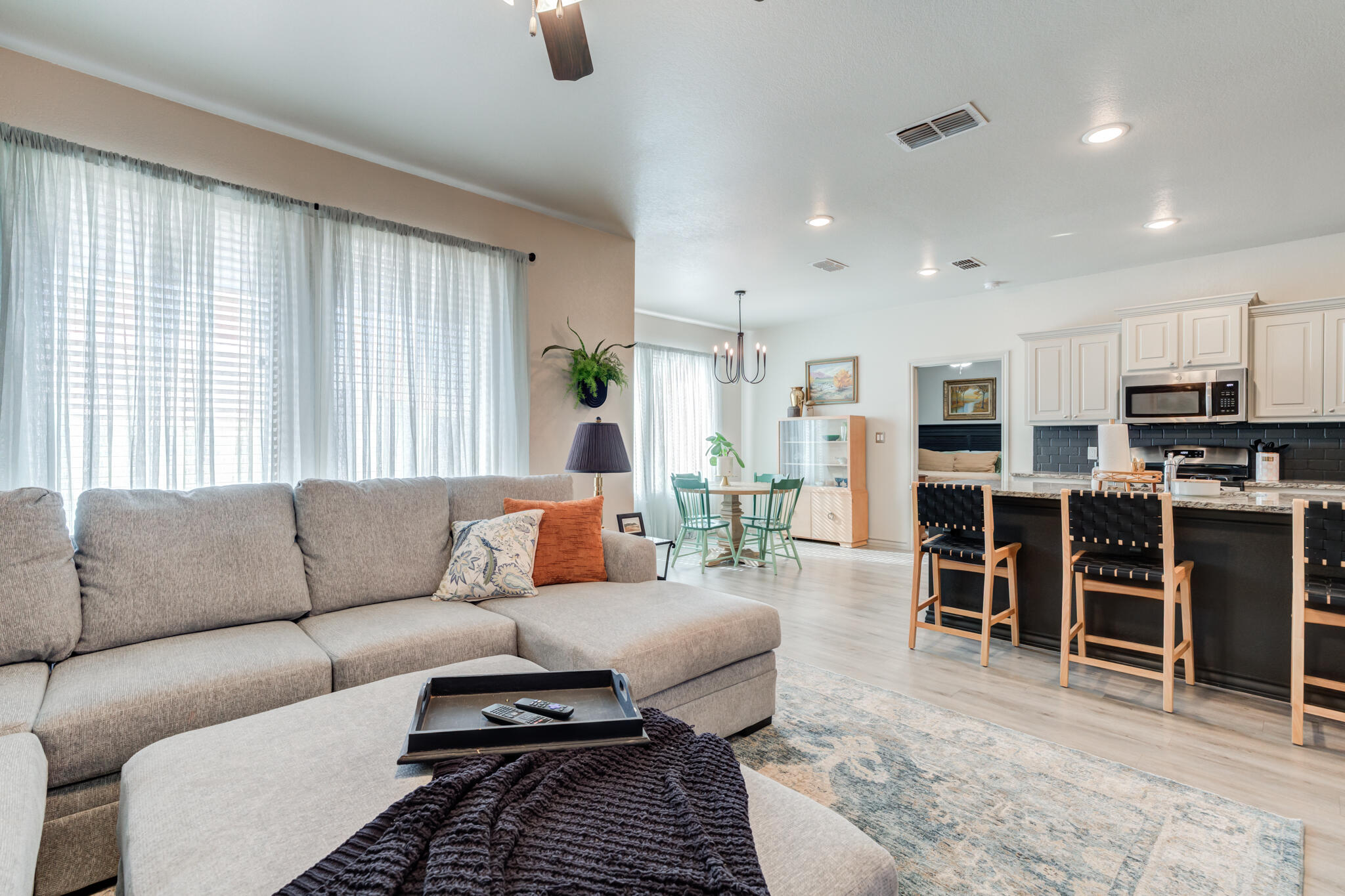 7813 88th Street Lubbock, TX 79424 - Photo 7 of 21 a living room with furniture kitchen view and a large window