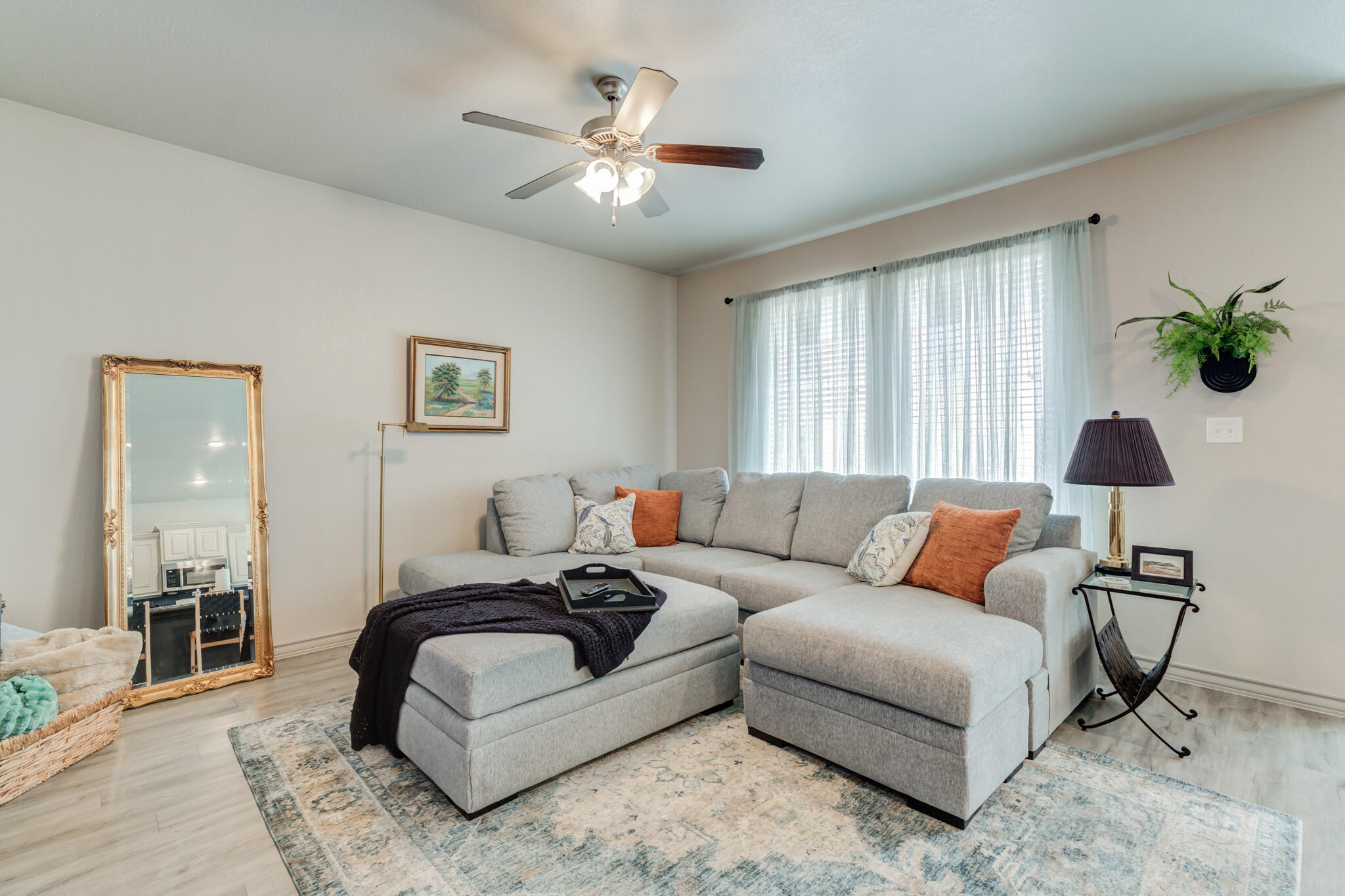 7813 88th Street Lubbock, TX 79424 - Photo 8 of 21 a living room with furniture and a chandelier