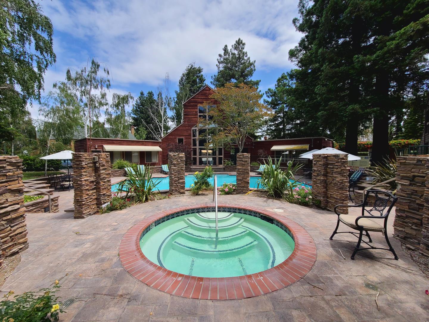 a swimming pool with an outdoor seating yard and barbeque oven