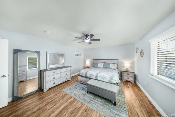 a bedroom with a large bed and a chandelier