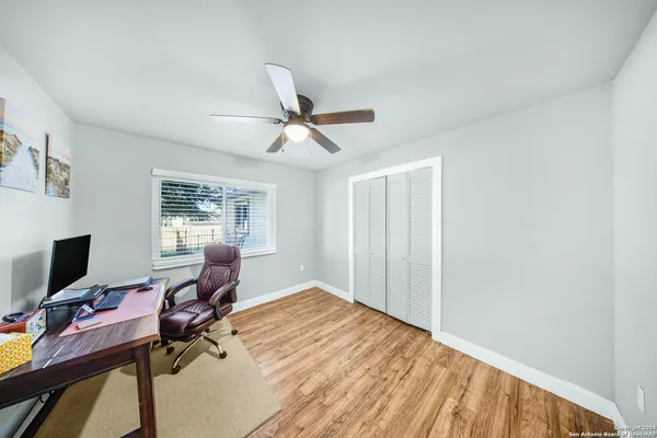 a workspace with a flat screen tv and a window