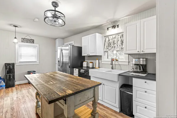 a kitchen with a stove cabinets and window