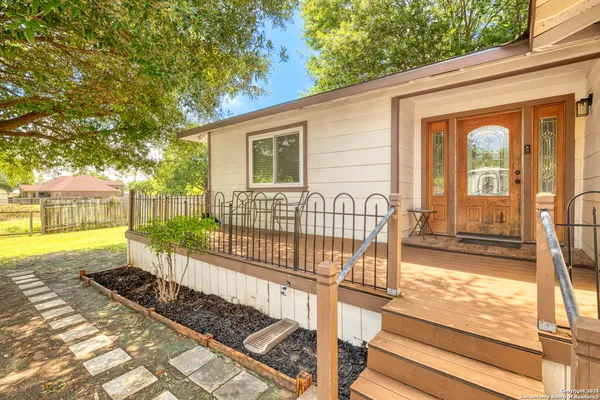 a view of a house with backyard and deck