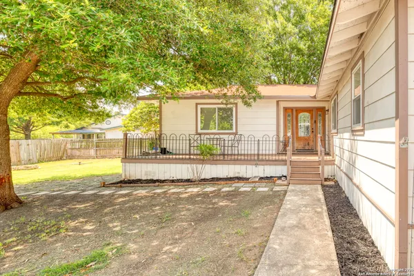 a front view of a house with a big yard