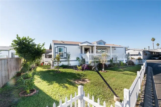 a front view of a house with a yard table and chairs